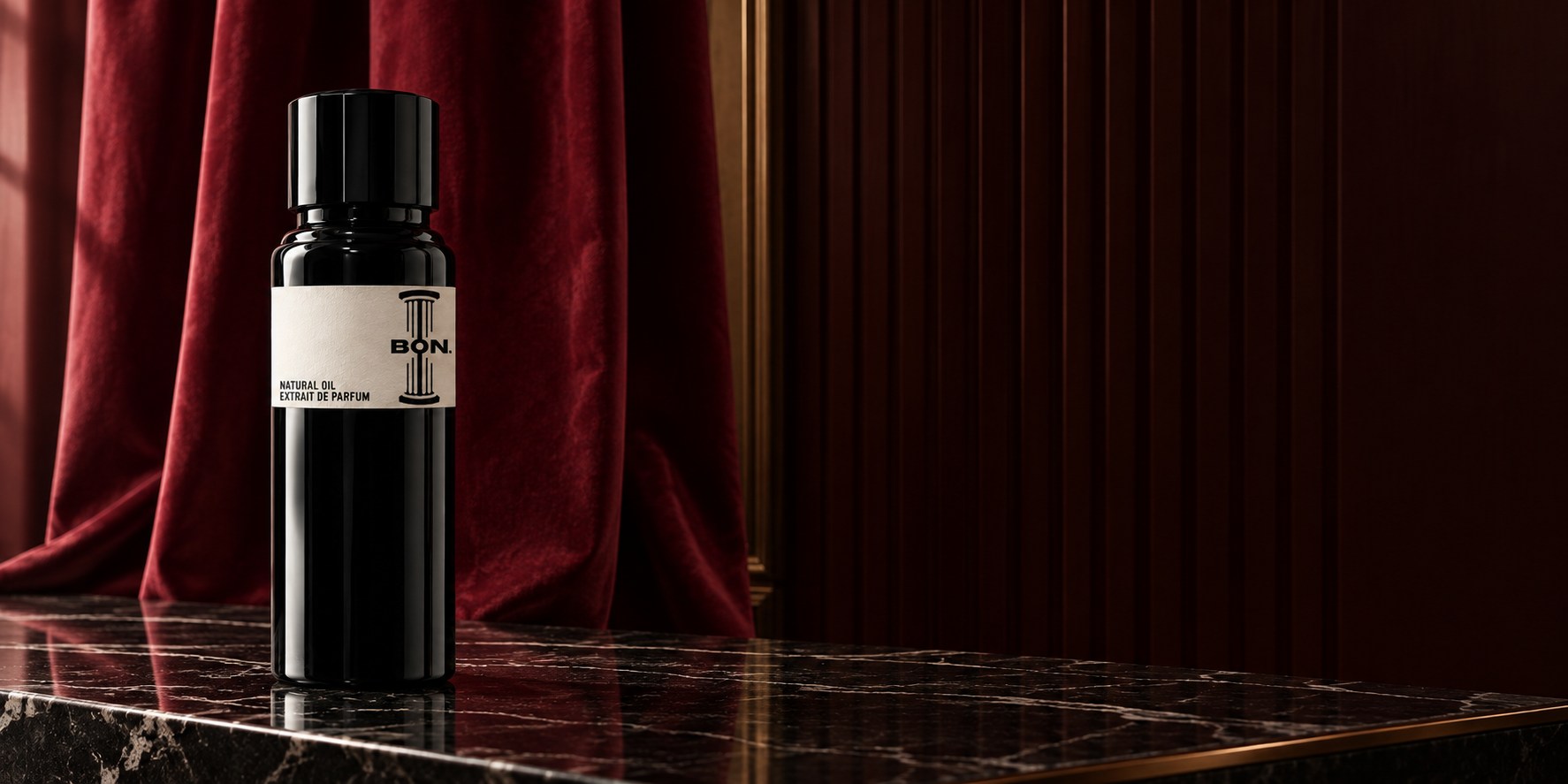 A black Bon bottle on dark marble in front of burgundy velvet.